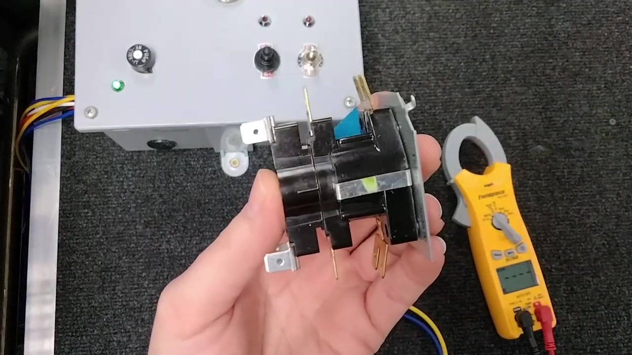 Closeup of a heat sequencer showing relay contacts and terminal connections