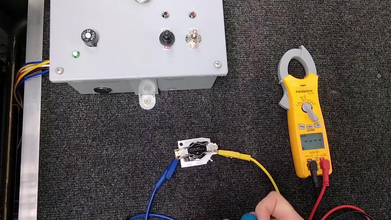 Inside view of a heat sequencer showing bimetal strip and contact mechanism