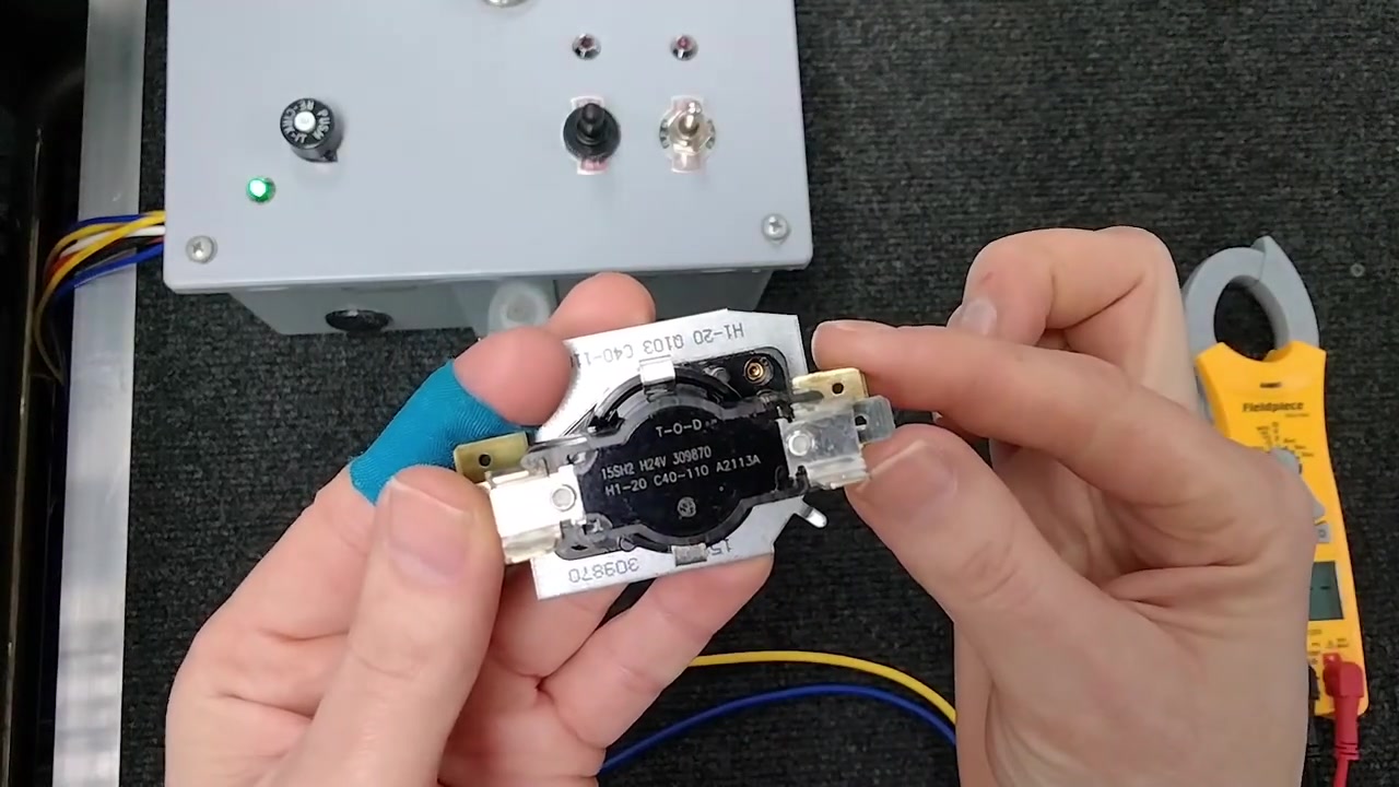 Multimeter reading on heat sequencer terminals during diagnostic test